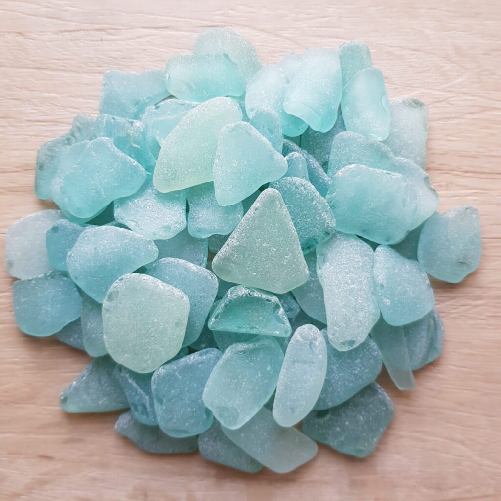 Beautiful sea foam sea glass pieces reflecting sunlight, showcasing their smooth textures.