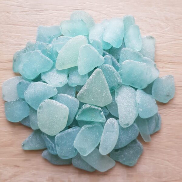 Beautiful sea foam sea glass pieces reflecting sunlight, showcasing their smooth textures.