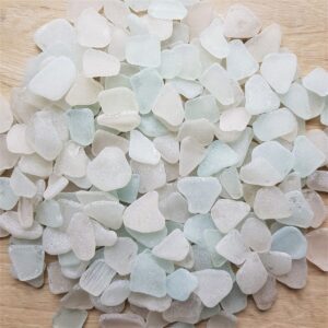 A collection of white sea glass pieces displayed on a smooth surface