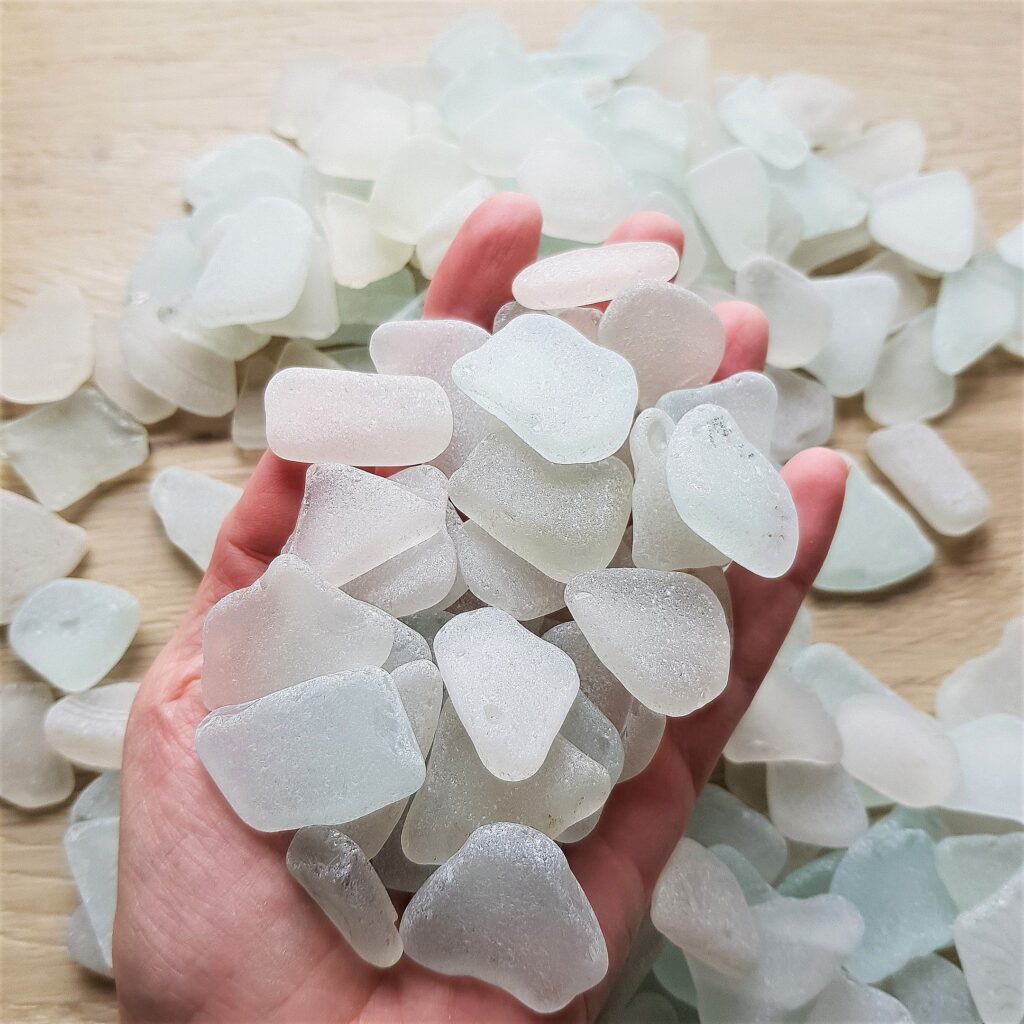 Handful of sea glass pieces in white.