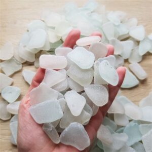 Handful of sea glass pieces in white.