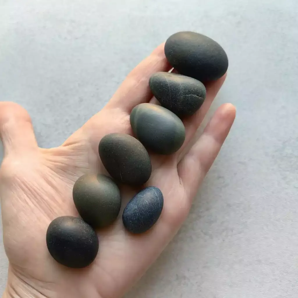 Handful of black beach pebbles