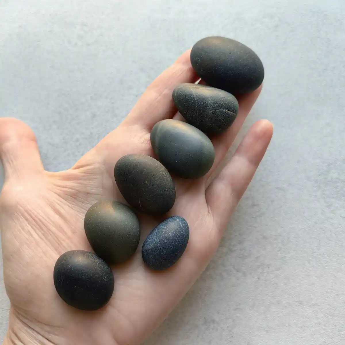 Handful of black beach pebbles