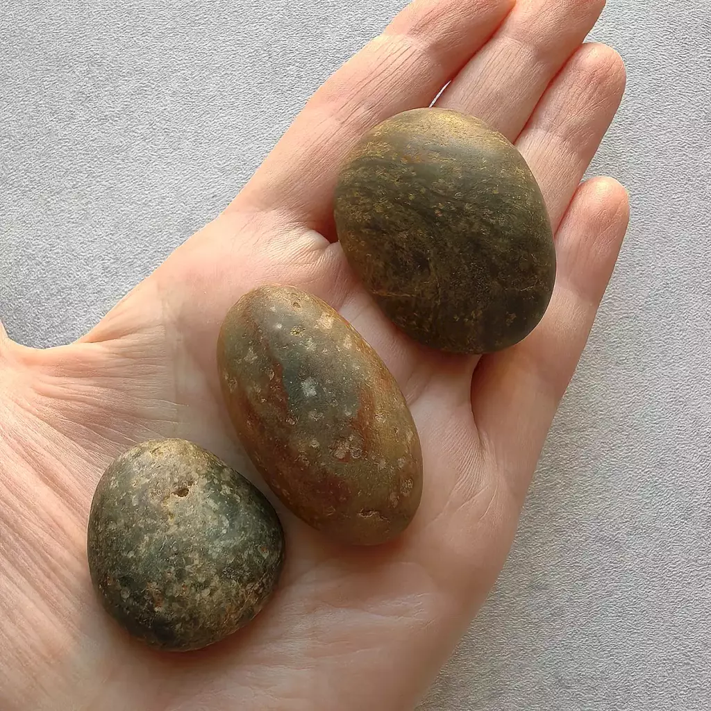 large pebbles displayed on a hand