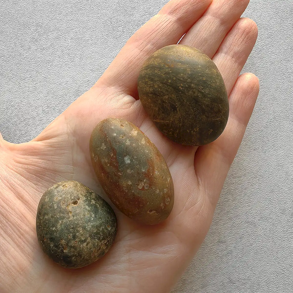 large pebbles displayed on a hand
