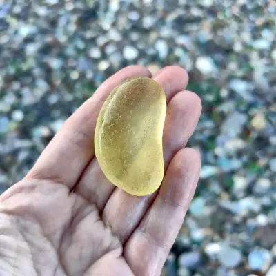 Yellow bottle bottom on a hand