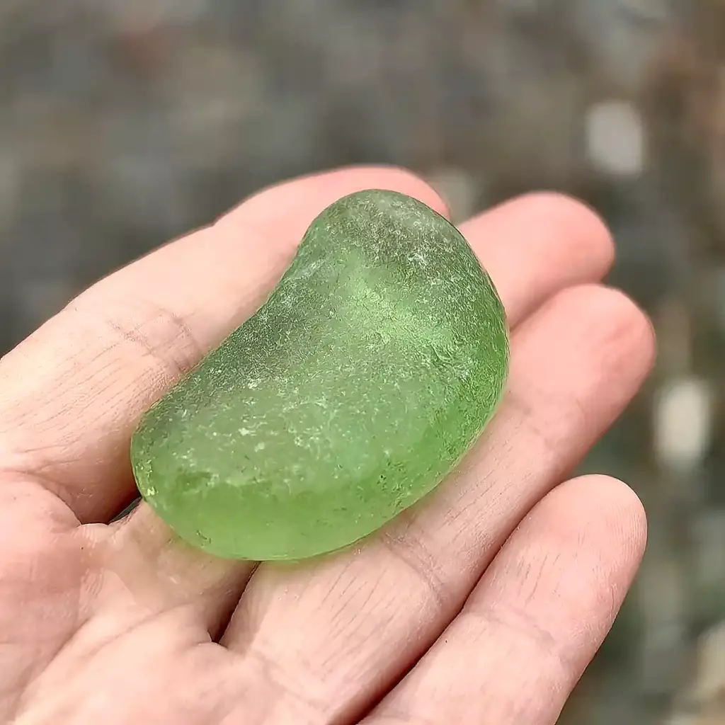Partial green bottom displayed on a hand