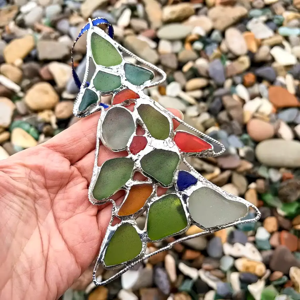 Sea glass Christmas tree suncatcher displayed on a hand