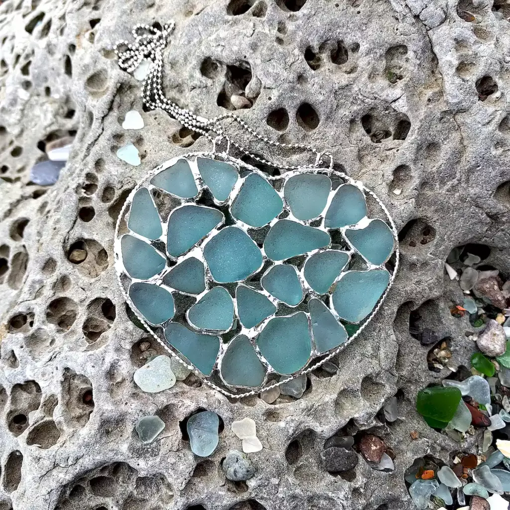 Stained Sea Glass Suncatcher displayed on a stone