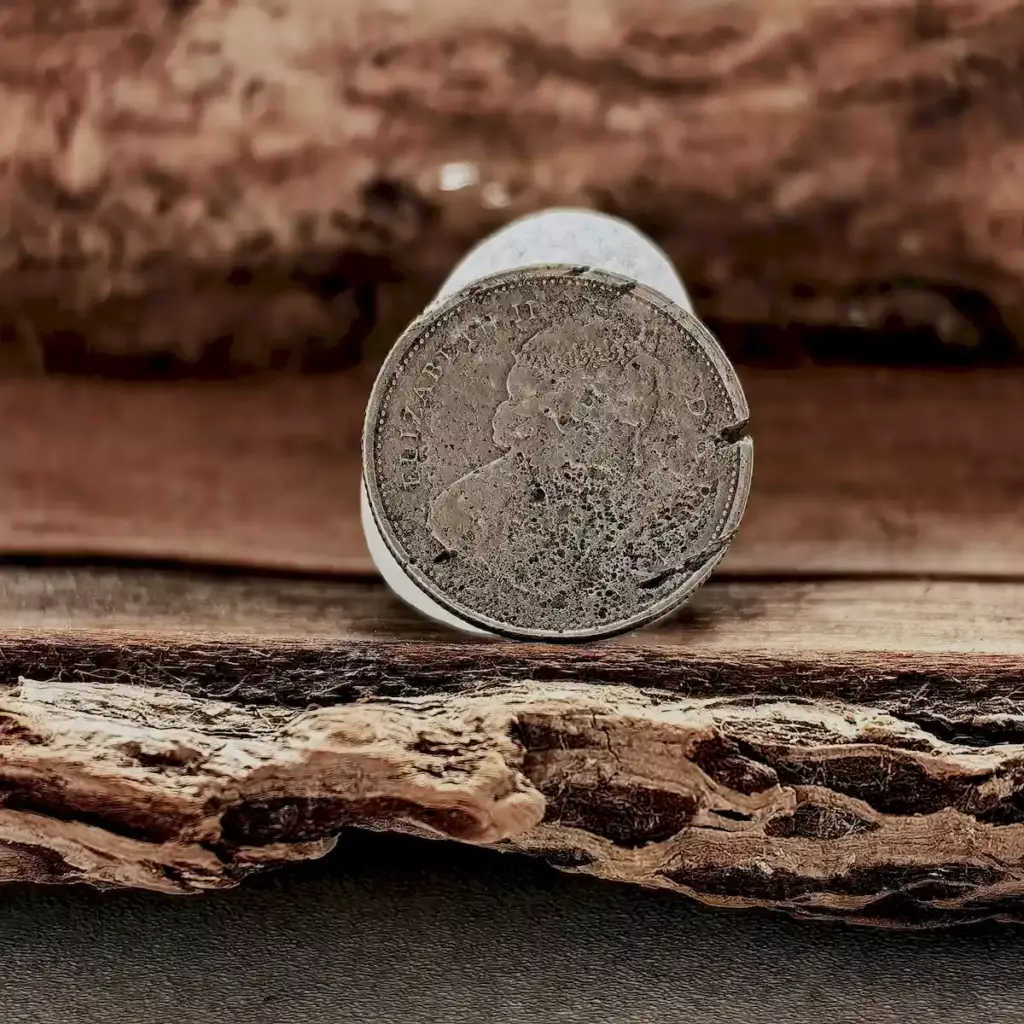 White sea glass with a coin