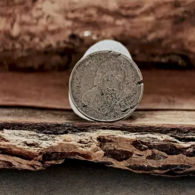 White sea glass with a coin