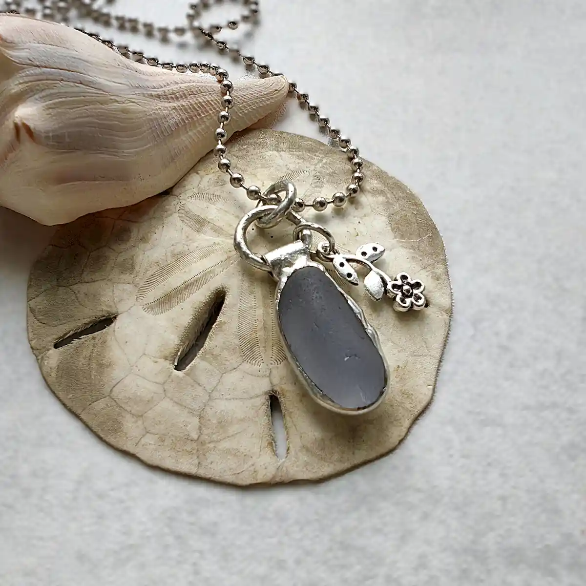 Minimalist grey sea glass necklace with flower charm - Japan sea glass