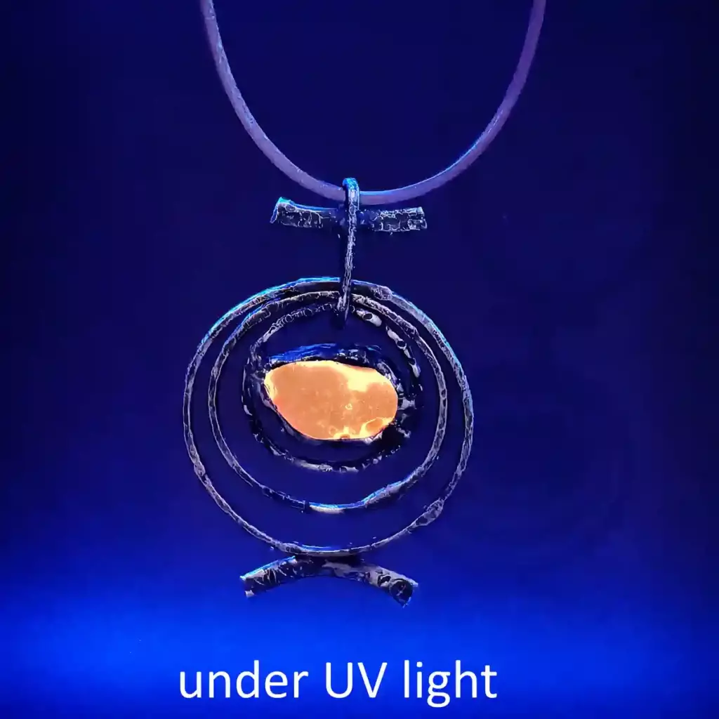 Red Orbit Necklace glowing under UV light -Japan sea glass
