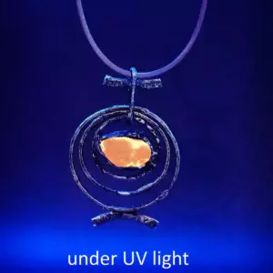 Red Orbit Necklace glowing under UV light -Japan sea glass