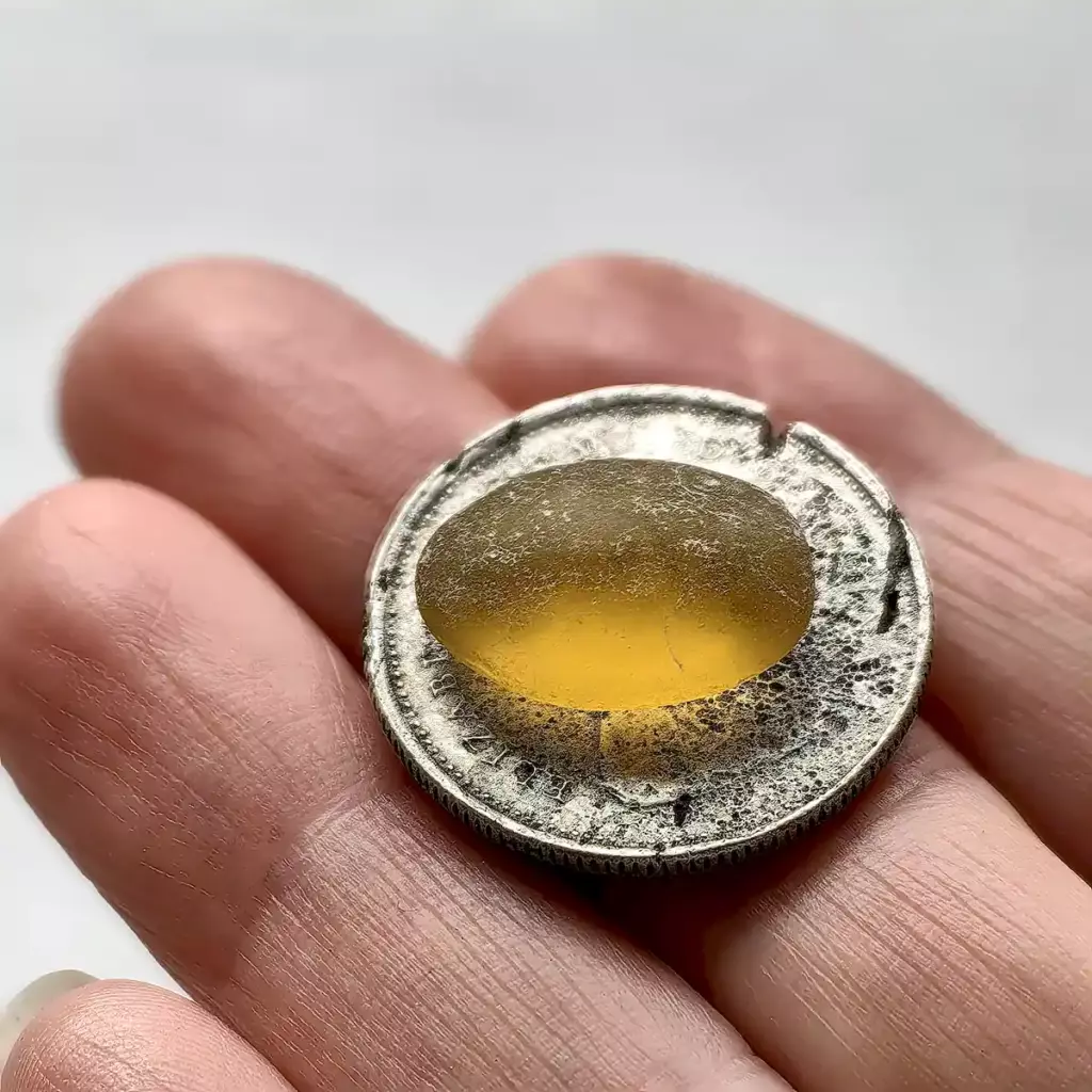 Honey sea glass gem on a coin